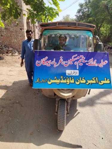 BILLBOARD ON VEHICLE UTILIZED FOR DISTRIBUTION OF RATIONS AND CLOTHING IN VILLIGES